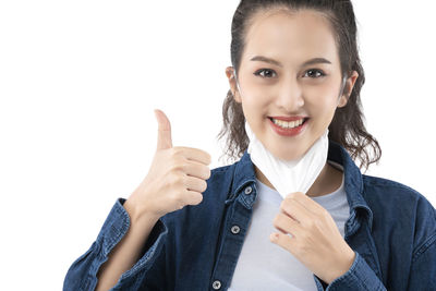 Portrait of smiling man standing against white background