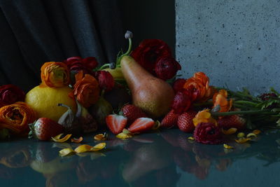 Close-up of fruits and flowers on table