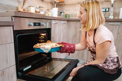 Midsection of woman preparing food at home