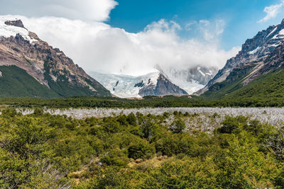 Scenic view of mountains against cloudy sky