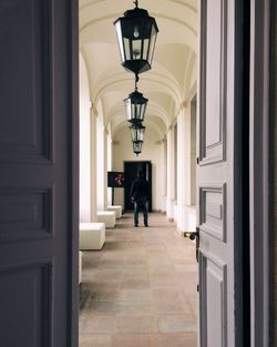 Rear view of man standing in corridor