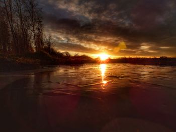 Scenic view of lake against sky during sunset