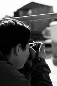 Portrait of boy holding camera