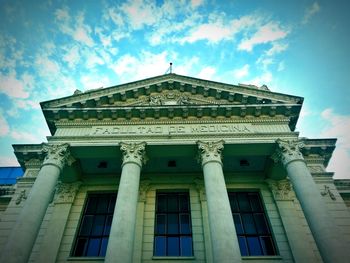 Low angle view of building against cloudy sky