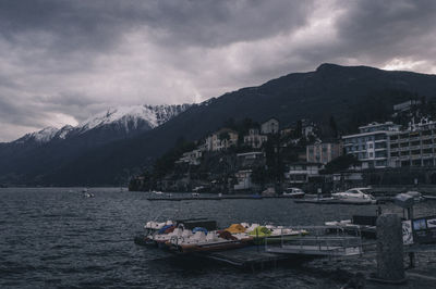 Scenic view of sea by buildings against sky