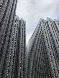 Low angle view of modern buildings against sky in city