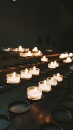 Lit tea light candles in temple