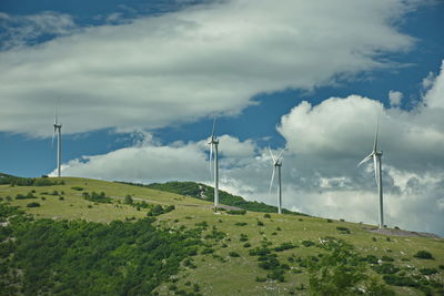 Windmill on field against sky