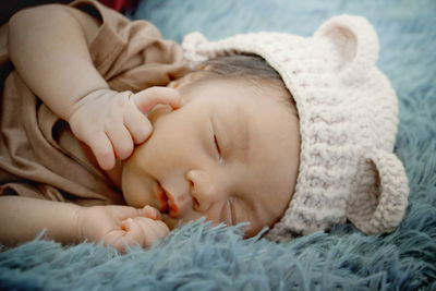 Close-up of baby boy sleeping on bed