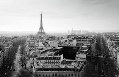 Eiffel tower amidst buildings in city