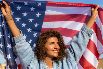 Portrait of woman holding american flag