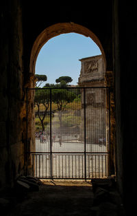 Built structure against sky seen through arch