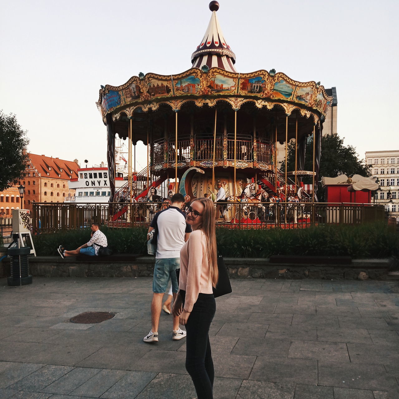 real people, leisure activity, architecture, built structure, lifestyles, sky, two people, men, building exterior, casual clothing, people, women, adult, full length, nature, day, togetherness, clear sky, rear view, amusement park, outdoors, positive emotion