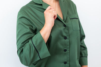 Midsection of woman standing against white background