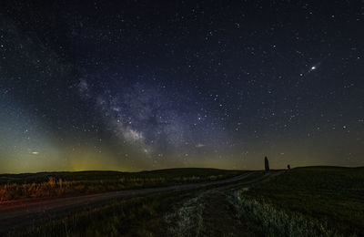 Scenic view of field against sky at night