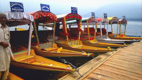 Panoramic view of boats moored in sea against sky