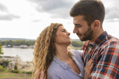 Happy young couple spending leisure time in public park