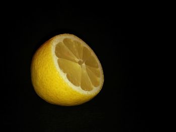 Close-up of orange slice over black background