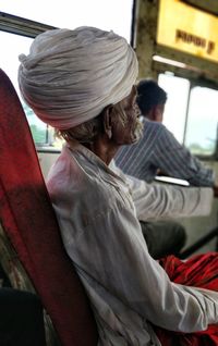 Rear view of woman sitting in bus
