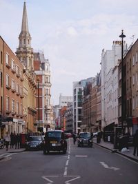 Vehicles on road along buildings