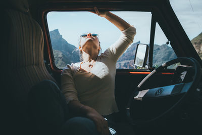 Rear view of woman sitting in car
