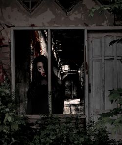 Portrait of woman standing in abandoned building