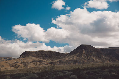 Scenic view of mountains against blue sky