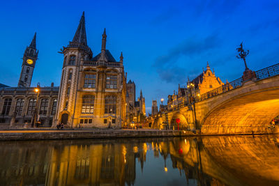 Reflection of illuminated buildings in city