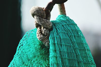 Close-up of net tied up with rope