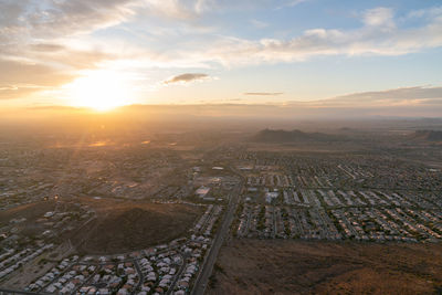 High angle view of city buildings against sky during sunset