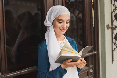 Young woman holding book