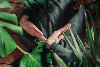 Midsection of man lying amidst plants