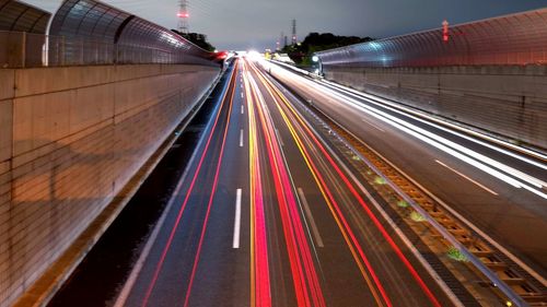 High angle view of light trails on road at night