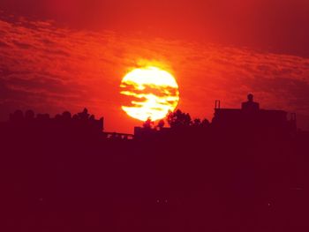 Silhouette of built structure at sunset