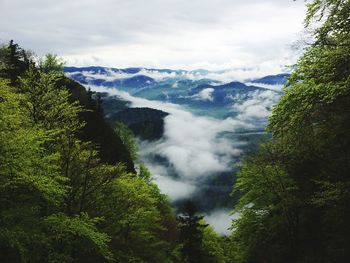 Scenic view of mountains against cloudy sky