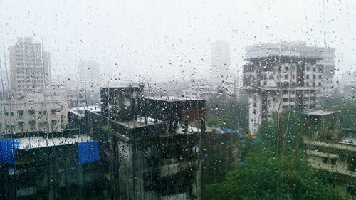 Buildings seen through wet window in rainy season