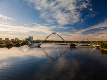 View of bridge over river against cloudy sky