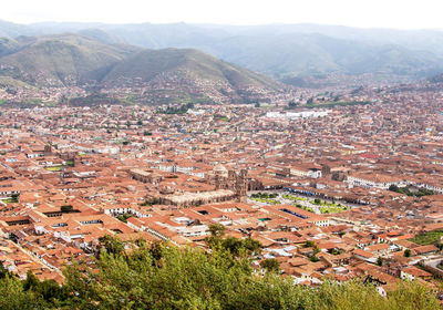 Aerial view of townscape by mountain