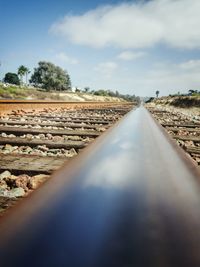 Surface level of railroad track against sky