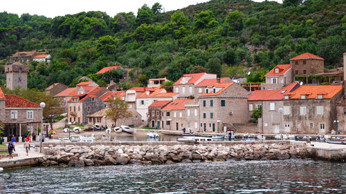 Buildings by river in town