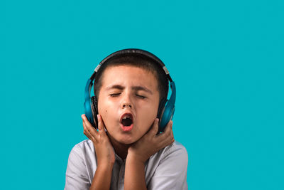 Portrait of boy against blue background