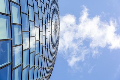 Low angle view of modern building against blue sky
