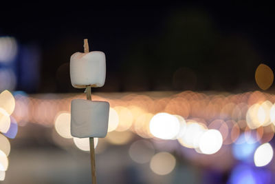 Close-up of illuminated candles against blurred background