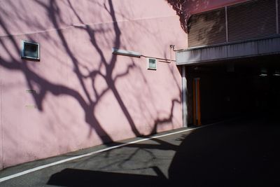 Sunlight falling on wall by building