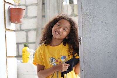 Portrait of smiling girl standing outdoors