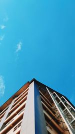 Low angle view of modern building against blue sky