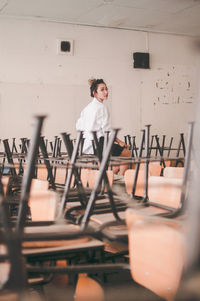 Portrait of young woman standing indoors