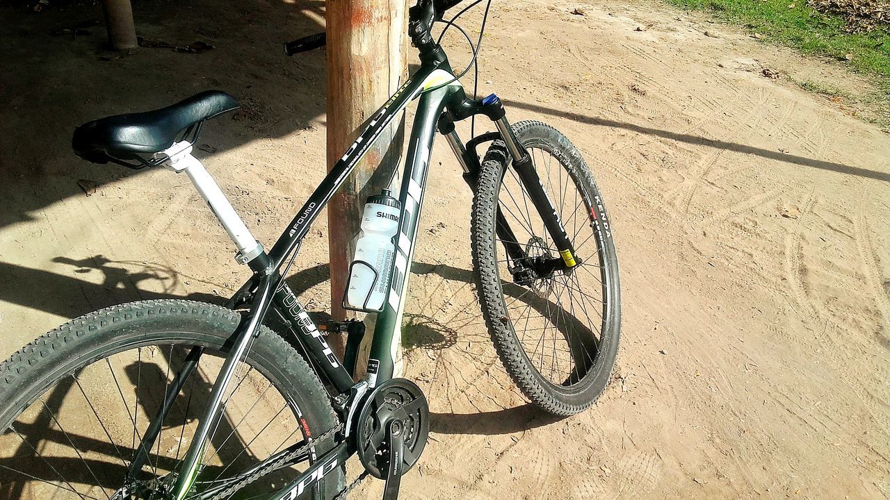 bicycle, transportation, mode of transport, stationary, land vehicle, day, parking, high angle view, no people, outdoors, sunlight, shadow, bicycle rack