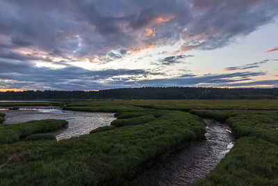 Scenic view of river against sky during sunset