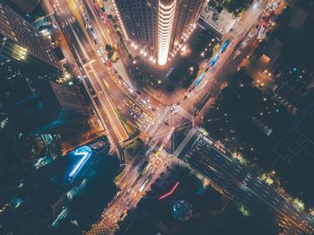 High angle view of illuminated road intersection in city at night